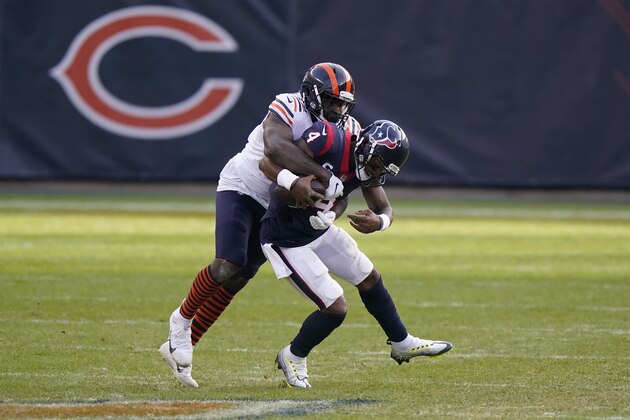 Houston Texans quarterback Deshaun Watson (4) is sacked by Chicago Bears' Mario Edwards (97) during the second half of an NFL football game, Sunday, Dec. 13, 2020, in Chicago. (AP Photo/Nam Y. Huh)