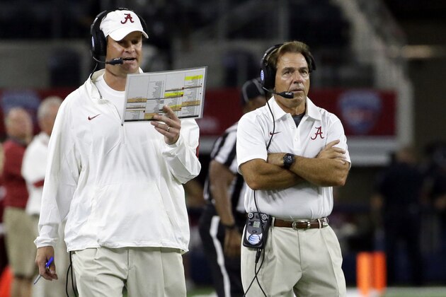 FILE - In this Sept. 5, 2015, file photo, Alabama head coach Nick Saban, right, looks on as offensive coordinator Lane Kiffin calls a play on the sidelines during the second half of an NCAA college football game against Wisconsin in Arlington, Texas.  Saban is taking a real gamble, even more than the onside kick he called in last year's national championship game, by switching up offensive coordinators a week before this year's title game. (AP Photo/LM Otero, File)