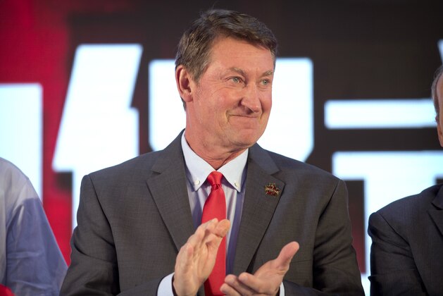 Former NHL hockey player Wayne Gretzky applauds during a promotional event for the Beijing Kunlun Red Star hockey team in his role as global ambassador for the team, part of the Russia-based Kontinental Hockey League, in Beijing, Thursday, Sept. 13, 2018. Gretzky says the NHL should again allow its players to compete in the Winter Olympics because sending the world's top hockey players is