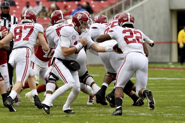 Alabama quarterback Mac Jones (10) hands off the ball to running back Najee Harris against Arkansas during the first half of an NCAA college football game Saturday, Dec. 12, 2020, in Fayetteville, Ark. (AP Photo/Michael Woods)
