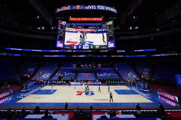 Philadelphia 76ers' Joel Embiid, left, and Boston Celtics' Robert Williams III leap for the tip-off to start an NBA preseason basketball game, Tuesday, Dec. 15, 2020, in Philadelphia. (AP Photo/Matt Slocum)