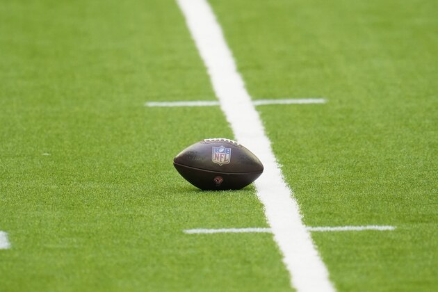 The NFL shield logo is seen on a Wilson NFL football as it sits on the field during an NFL football game between the New England Patriots and the Houston Texans, Sunday, Nov. 22, 2020, in Houston. (AP Photo/Matt Patterson)