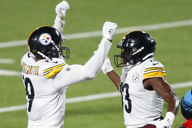 Pittsburgh Steelers wide receiver James Washington (13) celebrates with JuJu Smith-Schuster (19) after scoring on a 19-yard pass play with Buffalo Bills cornerback Levi Wallace (39) defending during the first half of an NFL football game in Orchard Park, N.Y., Sunday, Dec. 13, 2020. (AP Photo/Adrian Kraus)