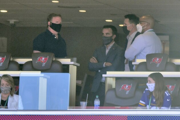 NFL commissioner Roger Goodell, left, talks to unidentified people in a suite during the second half of an NFL football game between the Minnesota Vikings and the Tampa Bay Buccaneers Sunday, Dec. 13, 2020, in Tampa, Fla. (AP Photo/Jason Behnken)