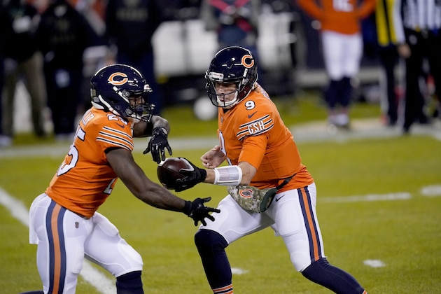 Chicago Bears quarterback Nick Foles (9) fakes a hand off to running back Lamar Miller during the first half of an NFL football game against the Minnesota Vikings Monday, Nov. 16, 2020, in Chicago. (AP Photo/Charles Rex Arbogast)