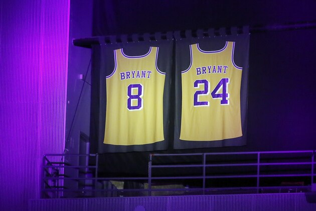 The retired jerseys of late Los Angeles Lakers Kobe Bryant hangs above the arena during an NBA game against the Portland Trail Blazers at Staples Center Friday, Jan. 31, 2020, in Los Angeles. Bryant, the 18-time NBA All-Star who won five championships and became one of the greatest basketball players of his generation during a 20-year career with the Los Angeles Lakers, died in a helicopter crash Sunday. (AP Photo/Ringo H.W. Chiu)