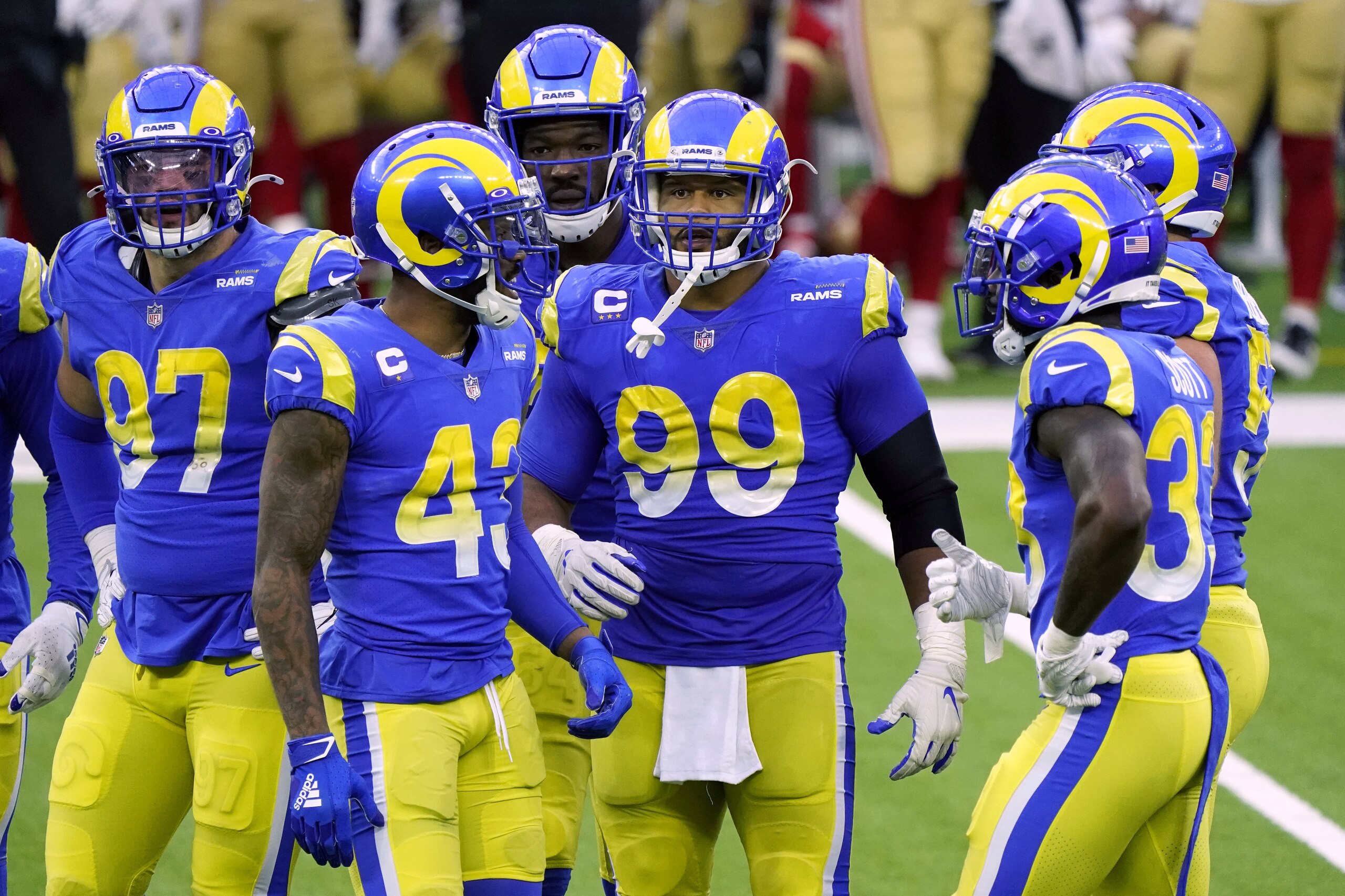 Los Angeles Rams defensive end Aaron Donald (99), and teammates in a break in the action during the second half of an NFL football game against the San Francisco 49ers Sunday, Nov. 29, 2020, in Inglewood, Calif. (AP Photo/Alex Gallardo)