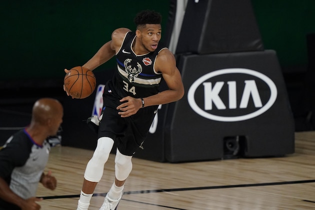 Milwaukee Bucks' Giannis Antetokounmpo (34) dribbles against the Miami Heat during the second half of an NBA conference semifinal playoff basketball game Wednesday, Sept. 2, 2020, in Lake Buena Vista, Fla. (AP Photo/Mark J. Terrill)