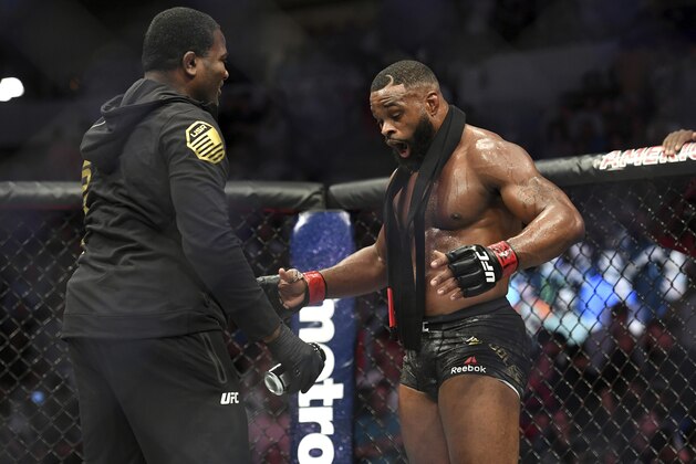 Tyron Woodley, right, reacts after defeating Darren Till by submission in their welterweight title mixed martial arts bout at UFC 228 on Saturday, Sept. 8, 2018, in Dallas. (AP Photo/Jeffrey McWhorter)