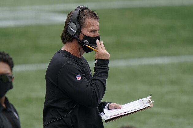 Las Vegas Raiders offensive coordinator Greg Olson gives signals from the sideline in the first half of an NFL football game against the New England Patriots, Sunday, Sept. 27, 2020, in Foxborough, Mass. (AP Photo/Steven Senne)