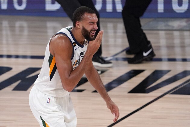 Utah Jazz's Rudy Gobert (27) reaches up after being hit in the face during play against the Denver Nuggets during the second half an NBA first round playoff basketball game, Tuesday, Sept. 1,2020, in Lake Buena Vista, Fla. (AP Photo/Mark J. Terrill)