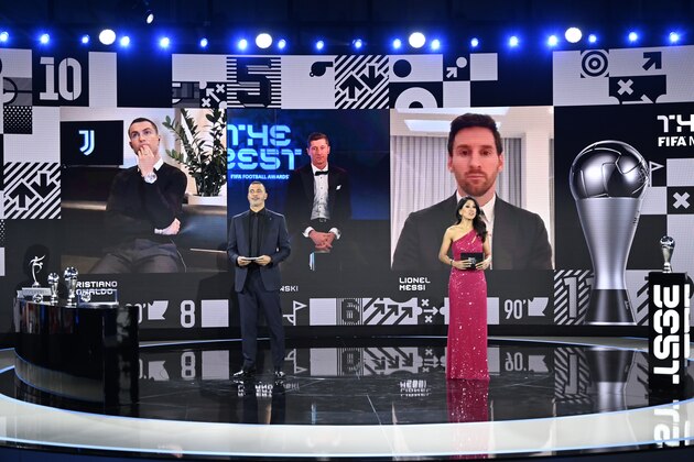 From left on the screen: Portugal's Cristiano Ronaldo, Poland's Robert Lewandowski and Argentina's Lionel Messi wait for hosts Reshmin Chowdhury, right, former Dutch soccer player Ruud Gullit, left, to announce the best player award during the Best FIFA Football Awards Ceremony in Zurich, Switzerland, Thursday, Dec. 17, 2020. (Valeriano Di Domenico/Pool via AP)