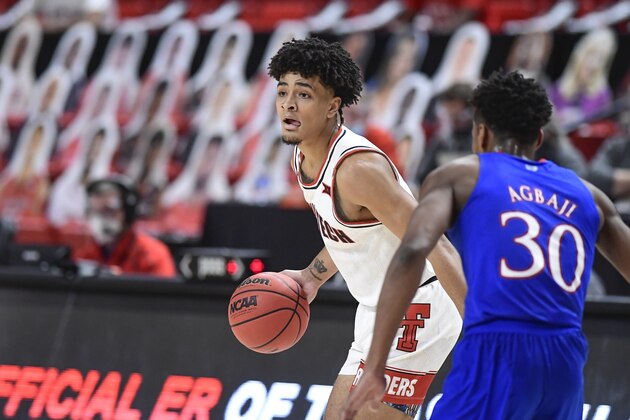 Texas Tech's Micah Peavy (5) attempts to pass the ball during the first half of an NCAA college basketball game against Kansas in Lubbock, Texas, Thursday, Dec. 17, 2020. (AP Photo/Justin Rex)