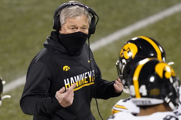Iowa head coach Kirk Ferentz talks to his players during the second half of an NCAA college football game against Illinois Saturday, Dec. 5, 2020, in Champaign , Ill. Iowa won 35-21. (AP Photo/Charles Rex Arbogast)