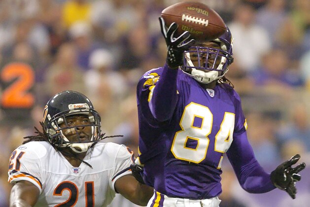 FILE - In this Sept. 26, 2004, file photo, Minnesota Vikings wide receiver Randy Moss (84) pulls in a 15-yard pass in front of Chicago Bears cornerback R.W. McQuarters (21) in the second quarter of an NFL football game in Minneapolis. Randy Moss, elected to the Pro Football Hall of Fame in his first year of eligibility, ranks second in NFL history with 156 career touchdown receptions and fourth with 15,292 career receiving yards. (AP Photo/Tom Olmscheid, File) FILE - In this Sept. 26, 2004, file photo, Minnesota Vikings wide receiver Randy Moss (84) pulls in a 15-yard pass in front of Chicago Bears cornerback R.W. McQuarters (21) in the second quarter of an NFL football game in Minneapolis. Randy Moss, elected to the Pro Football Hall of Fame in his first year of eligibility, ranks second in NFL history with 156 career touchdown receptions and fourth with 15,292 career receiving yards. (AP Photo/Tom Olmscheid, File)