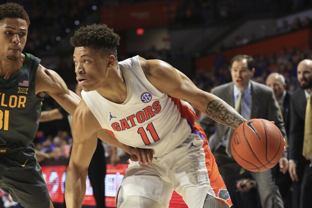 Florida forward Keyontae Johnson (11) dribbles around Baylor guard MaCio Teague (31) during the first half of an NCAA college basketball game Saturday, Jan. 25, 2020, in Gainesville, Fla. (AP Photo/Matt Stamey)