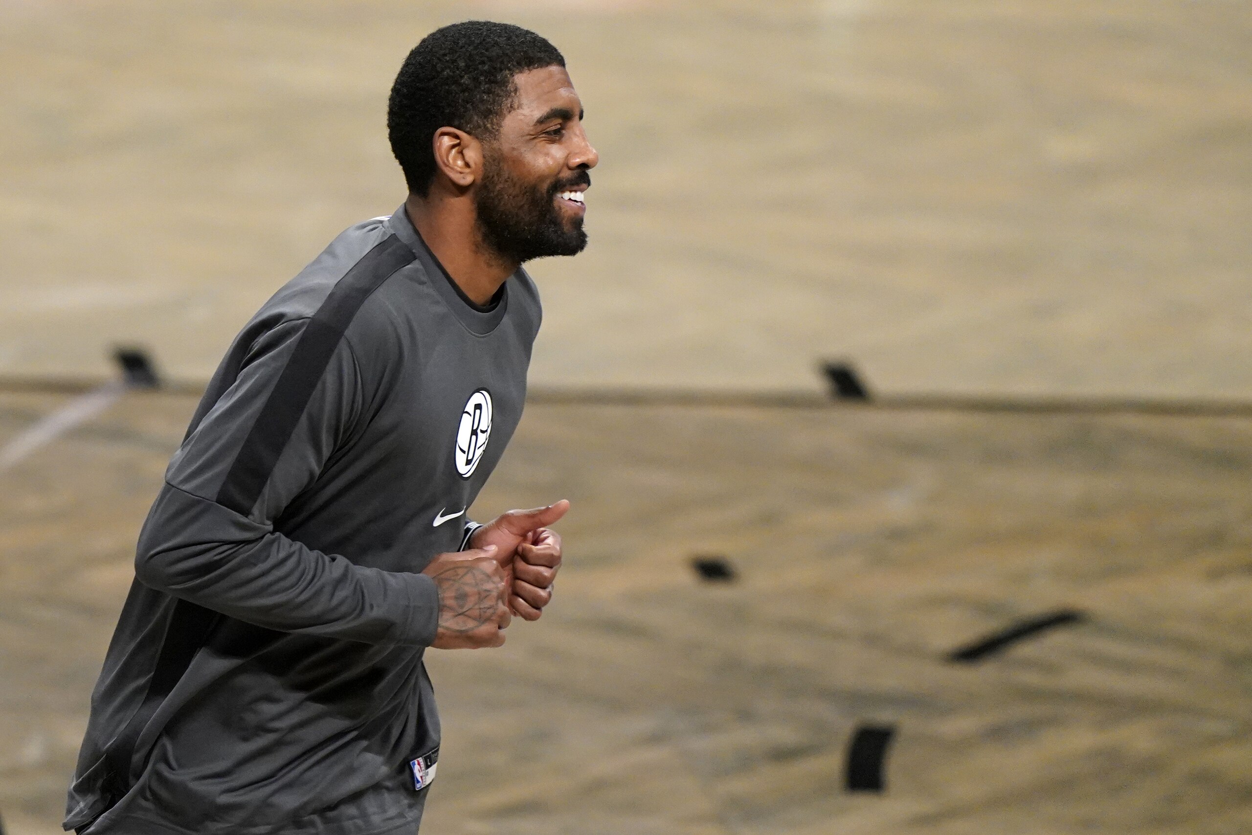 Brooklyn Nets guard Kyrie Irving smiles as he runs on the court before a preseason NBA basketball game against the Washington Wizards, Sunday, Dec. 13, 2020, in New York. (AP Photo/Kathy Willens) Brooklyn Nets guard Kyrie Irving smiles as he runs on the court before a preseason NBA basketball game against the Washington Wizards, Sunday, Dec. 13, 2020, in New York. (AP Photo/Kathy Willens)
