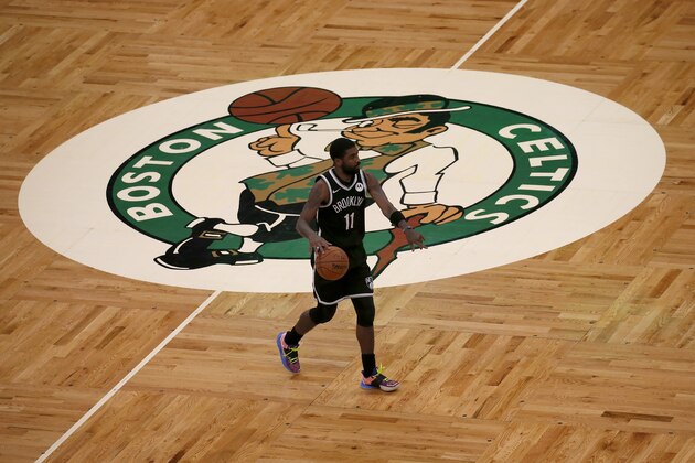 Brooklyn Nets guard Kyrie Irving (11) dribbles the ball past center court during the first half of an NBA preseason basketball game against the Boston Celtics, Friday, Dec. 18, 2020, in Boston. (AP Photo/Mary Schwalm)