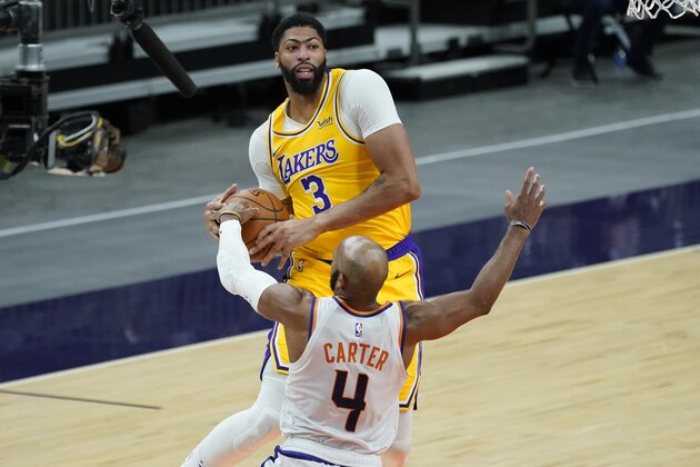 Los Angeles Lakers forward Anthony Davis (3) is fouled by Phoenix Suns guard Jevon Carter (4) during the first half of a preseason basketball game, Friday, Dec. 18, 2020, in Phoenix, Ariz. (AP Photo/Matt York) Los Angeles Lakers forward Anthony Davis (3) is fouled by Phoenix Suns guard Jevon Carter (4) during the first half of a preseason basketball game, Friday, Dec. 18, 2020, in Phoenix, Ariz. (AP Photo/Matt York)