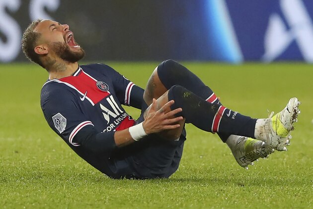 PSG's Neymar falls in pain during the League One soccer match between Paris Saint Germain and Lyon, at the Parc des Princes stadium in Paris, France, Sunday, Dec. 13, 2020. (AP Photo/Thibault Camus)