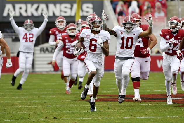 Alabama punt returner DeVonta Smith (6) returns a punt for a touchdown against Arkansas during the first half of an NCAA college football game Saturday, Dec. 12, 2020, in Fayetteville, Ark. (AP Photo/Michael Woods)
