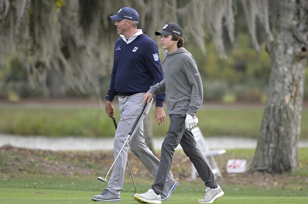 Matt Kuchar, left, and his son Cameron walk on the 11th hole during a pro-am round of the PNC Championship golf tournament, Thursday, Dec. 17, 2020, in Orlando, Fla. (AP Photo/Phelan M. Ebenhack)