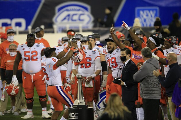 Clemson linebacker Mike Jones Jr. (6) holds up the trophy as he celebrates with teammates following their 34-10 victory over Notre Dame at the Atlantic Coast Conference championship NCAA college football game, Saturday, Dec. 19, 2020, in Charlotte, N.C. (AP Photo/Brian Blanco)