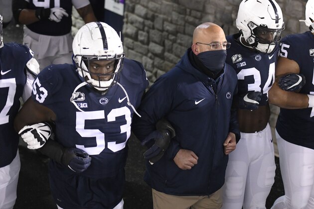 Penn State head coach James Franklin leads his team onto the field for an NCAA college football game against Illinois in State College, Pa., on Saturday, Dec. 19, 2020. (AP Photo/Barry Reeger)