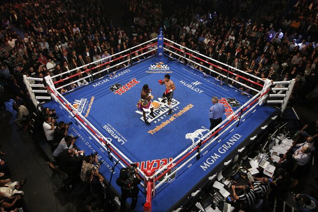 FILE - In this Jan. 19, 2019, file photo, Manny Pacquiao, center right, fights Adrien Broner in a WBA welterweight title boxing match in Las Vegas. A spokesman for Pacquiao says the famed fighter's Los Angeles home was robbed at about the time he was in the ring with rival Adrien Broner in Las Vegas. Spokesman Mike Quinn confirmed the burglary to NBC News. Los Angeles police said a burglary was reported about 4:15 p.m. Sunday, Jan. 20, 2019. in the Larchmont neighborhood. (AP Photo/John Locher, File) FILE - In this Jan. 19, 2019, file photo, Manny Pacquiao, center right, fights Adrien Broner in a WBA welterweight title boxing match in Las Vegas. A spokesman for Pacquiao says the famed fighter's Los Angeles home was robbed at about the time he was in the ring with rival Adrien Broner in Las Vegas. Spokesman Mike Quinn confirmed the burglary to NBC News. Los Angeles police said a burglary was reported about 4:15 p.m. Sunday, Jan. 20, 2019. in the Larchmont neighborhood. (AP Photo/John Locher, File)