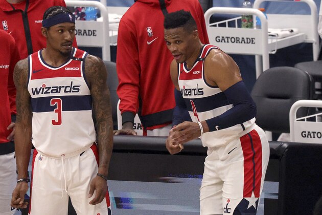 Washington Wizards Bradley Beal (3) and Russell Westbrook (4) talk during a timeout during the first half of a preseason NBA basketball game against the Detroit Pistons, Saturday, Dec. 19, 2020 in Washington. (Rob Carr/Getty Images via AP, Pool)
