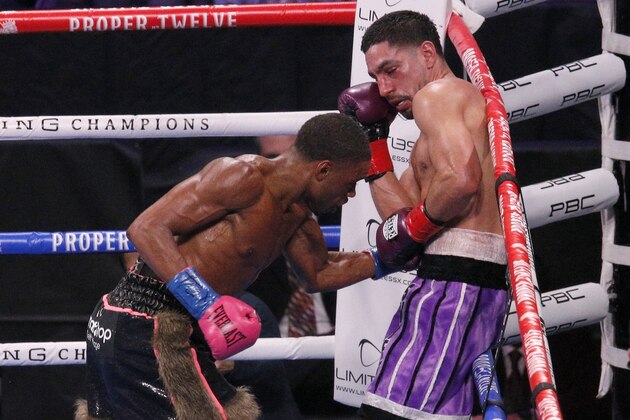 Errol Spence Jr., left, delivers a body punch to Danny Garcia, during the WBC-IBF welterweight boxing bout in Arlington, Texas, Saturday, Dec. 5, 2020. (AP Photo/Brandon Wade)