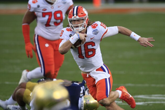 Clemson quarterback Trevor Lawrence (16) runs the ball during the first half of the Atlantic Coast Conference championship NCAA college football game against Notre Dame, Saturday, Dec. 19, 2020, in Charlotte, N.C. (AP Photo/Brian Blanco)