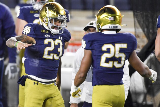 Notre Dame running back Kyren Williams (23) congratulates teammate Chris Tyree (25) after his touchdown against Syracuse in an NCAA college football game Saturday, Dec. 5, 2020, in South Bend, Ind. (Matt Cashore/Pool Photo via AP)