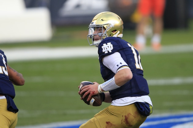 Notre Dame quarterback Ian Book (12) looks for a receiver during the first half of the Atlantic Coast Conference championship NCAA college football game against Clemson, Saturday, Dec. 19, 2020, in Charlotte, N.C. (AP Photo/Brian Blanco)