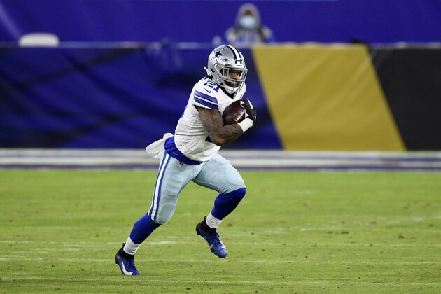 Dallas Cowboys running back Ezekiel Elliott (21) runs with the ball during the second half of an NFL football game against the Baltimore Ravens, Tuesday, Dec. 8, 2020, in Baltimore. (AP Photo/Nick Wass)