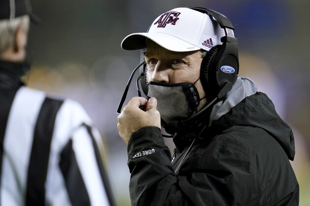 Texas A&M head coach Jimbo Fisher talks to a game official before the start of an NCAA college football game against LSU, Saturday, Nov. 28, 2020. in College Station, Texas. (AP Photo/Sam Craft)