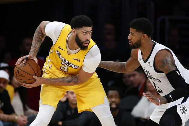 Los Angeles Lakers' Anthony Davis (3) is defended by Los Angeles Clippers' Paul George (13) during an NBA basketball game between Los Angeles Lakers and Los Angeles Clippers, Wednesday, Dec. 25, 2019, in Los Angeles. The Clippers won 111-106. (AP Photo/Ringo H.W. Chiu)