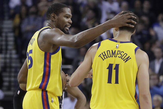 Golden State Warriors forward Kevin Durant, left, celebrates with Klay Thompson during the second half of the team's NBA basketball game against the San Antonio Spurs in Oakland, Calif., Thursday, March 8, 2018. (AP Photo/Jeff Chiu)