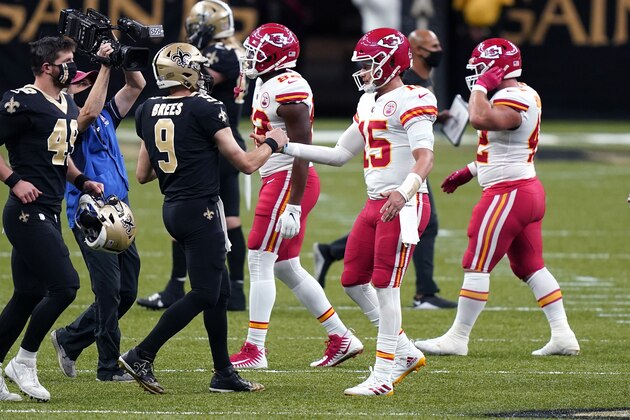 New Orleans Saints quarterback Drew Brees (9) greets Kansas City Chiefs quarterback Patrick Mahomes (15) after an NFL football game in New Orleans, Sunday, Dec. 20, 2020. (AP Photo/Butch Dill)
