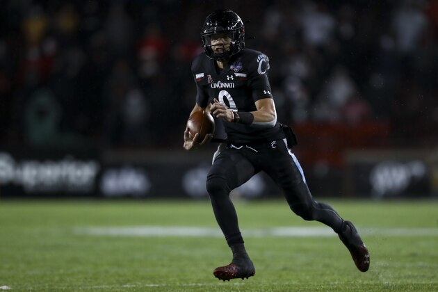 Cincinnati quarterback Desmond Ridder carries the ball during the second half of the American Athletic Conference championship NCAA college football game against Tulsa, Saturday, Dec. 19, 2020, in Cincinnati. Cincinnati won 27-24. (AP Photo/Aaron Doster)