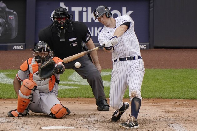 New York Yankees DJ LeMahieu bats in a baseball game against the Baltimore Orioles, Sunday, Sept. 13, 2020, at Yankee Stadium in New YorkBaltimore Orioles catcher Pedro Severino (28) is at left, and (AP Photo/Kathy Willens)