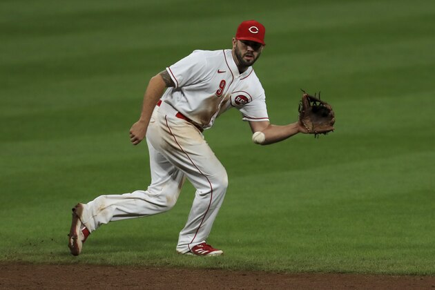 Cincinnati Reds' Mike Moustakas fields the ball during a baseball game against the Milwaukee Brewers in Cincinnati, Tuesday, Sept. 22, 2020. The Brewers won 3-2. (AP Photo/Aaron Doster)