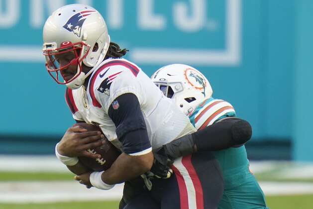 Miami Dolphins defensive end Emmanuel Ogbah (91) sacks New England Patriots quarterback Cam Newton (1), during the second half of an NFL football game, Sunday, Dec. 20, 2020, in Miami Gardens, Fla. The Dolphins defeated the Patriots 22-12. (AP Photo/Chris O'Meara)