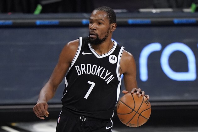 Brooklyn Nets forward Kevin Durant handles the ball during the first half of a preseason NBA basketball game against the Washington Wizards, Sunday, Dec. 13, 2020, in New York. (AP Photo/Kathy Willens)