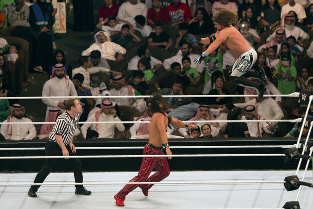 World Wrestling Entertainment stars AJ Styles, top, and Shinsuke Nakamura, wrestle during their match at the