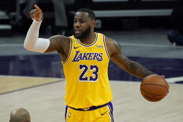 Los Angeles Lakers forward LeBron James (23) calls a play against the Phoenix Suns during the first half of a preseason NBA basketball game, Friday, Dec. 18, 2020, in Phoenix, Ariz. (AP Photo/Matt York) Los Angeles Lakers forward LeBron James (23) calls a play against the Phoenix Suns during the first half of a preseason NBA basketball game, Friday, Dec. 18, 2020, in Phoenix, Ariz. (AP Photo/Matt York)