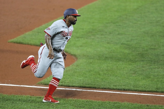 Washington Nationals' Howie Kendrick runs to home plate before scoring a run against the Baltimore Orioles during the fourth inning of a baseball game, Friday, Aug. 14, 2020, in Baltimore. (AP Photo/Julio Cortez)