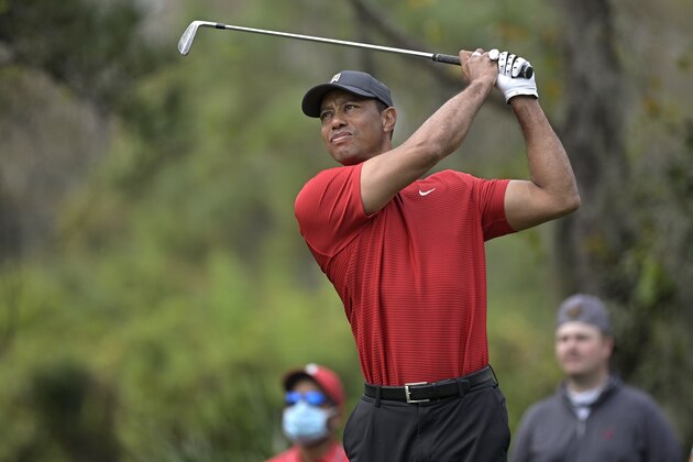 Tiger Woods watches his tee shot on the fourth hole during the final round of the PNC Championship golf tournament, Sunday, Dec. 20, 2020, in Orlando, Fla. (AP Photo/Phelan M. Ebenhack)