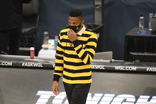 Washington Wizards guard Russell Westbrook wears a facemask to protect against Covid-19 as he looks on during the first half of a preseason NBA basketball game against the Detroit Pistons, Thursday, Dec. 17, 2020, in Washington. (AP Photo/Nick Wass)