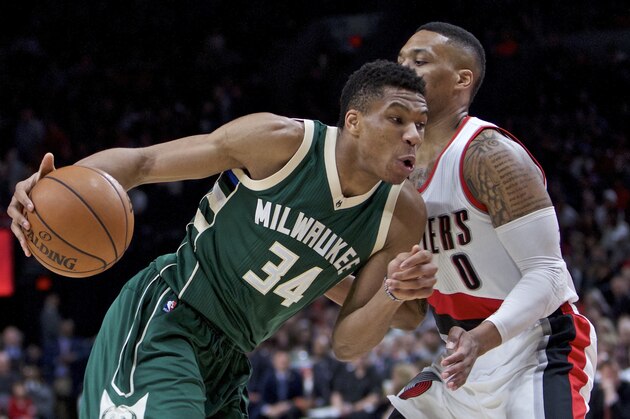 Milwaukee Bucks forward Giannis Antetokounmpo, left, dribbles past Portland Trail Blazers guard Damian Lillard during the first half of an NBA basketball game in Portland, Ore., Tuesday, March 21, 2017. (AP Photo/Craig Mitchelldyer)